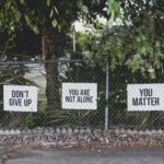signs on a car park fence