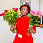Lady in red dress holding flowers
