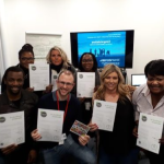 7 people holding up certificates